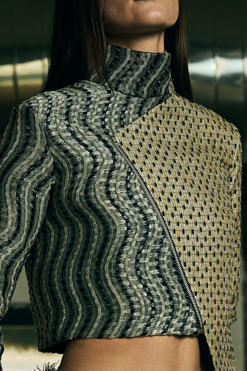 Handwoven asymmetric biker jacket by AKHL featuring rugged leather and unique design details, shown on a hanger.