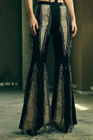 Handwoven panelled boot-cut trousers from AKHL, featuring intricate design and tailored fit, shown in a stylish pants image.