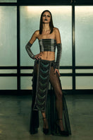 Sheer panelled fringe maxi skirt by AKHL featuring flowing fabric and layered fringe details on a neutral background.