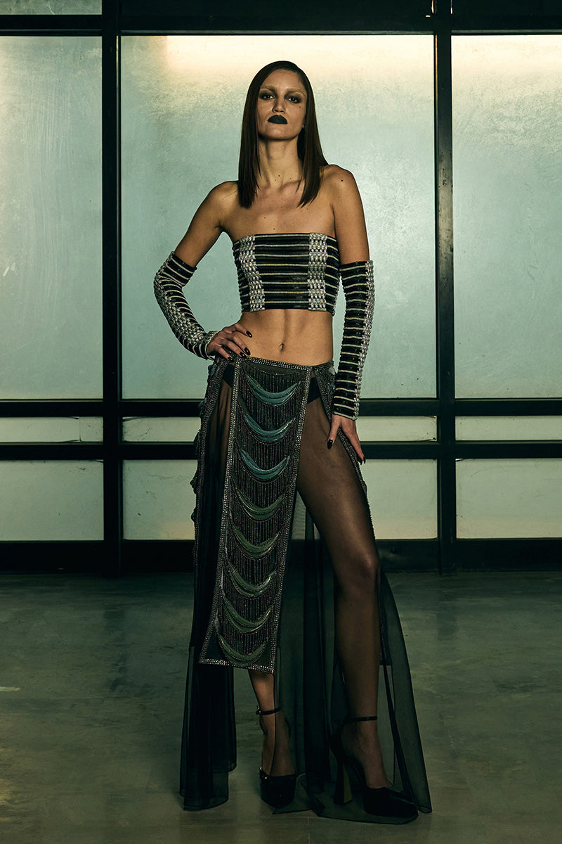 Sheer panelled fringe maxi skirt by AKHL featuring flowing fabric and layered fringe details on a neutral background.