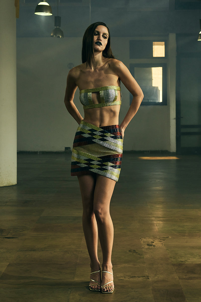 Black INTERWOVEN COLUMN mini skirt by AKHL displayed on a mannequin, showcasing its textured woven fabric and fitted silhouette.