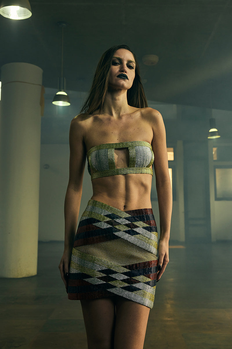 Black INTERWOVEN COLUMN mini skirt by AKHL featuring a fitted waistband and woven fabric texture.