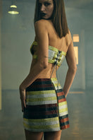 Black interwoven column mini skirt from AKHL with a fitted silhouette, shown on a model against a neutral background.