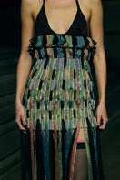 Black AKHL dimensional column maxi skirt with structured design and flowy fabric, styled as a fashionable women's skirt.
