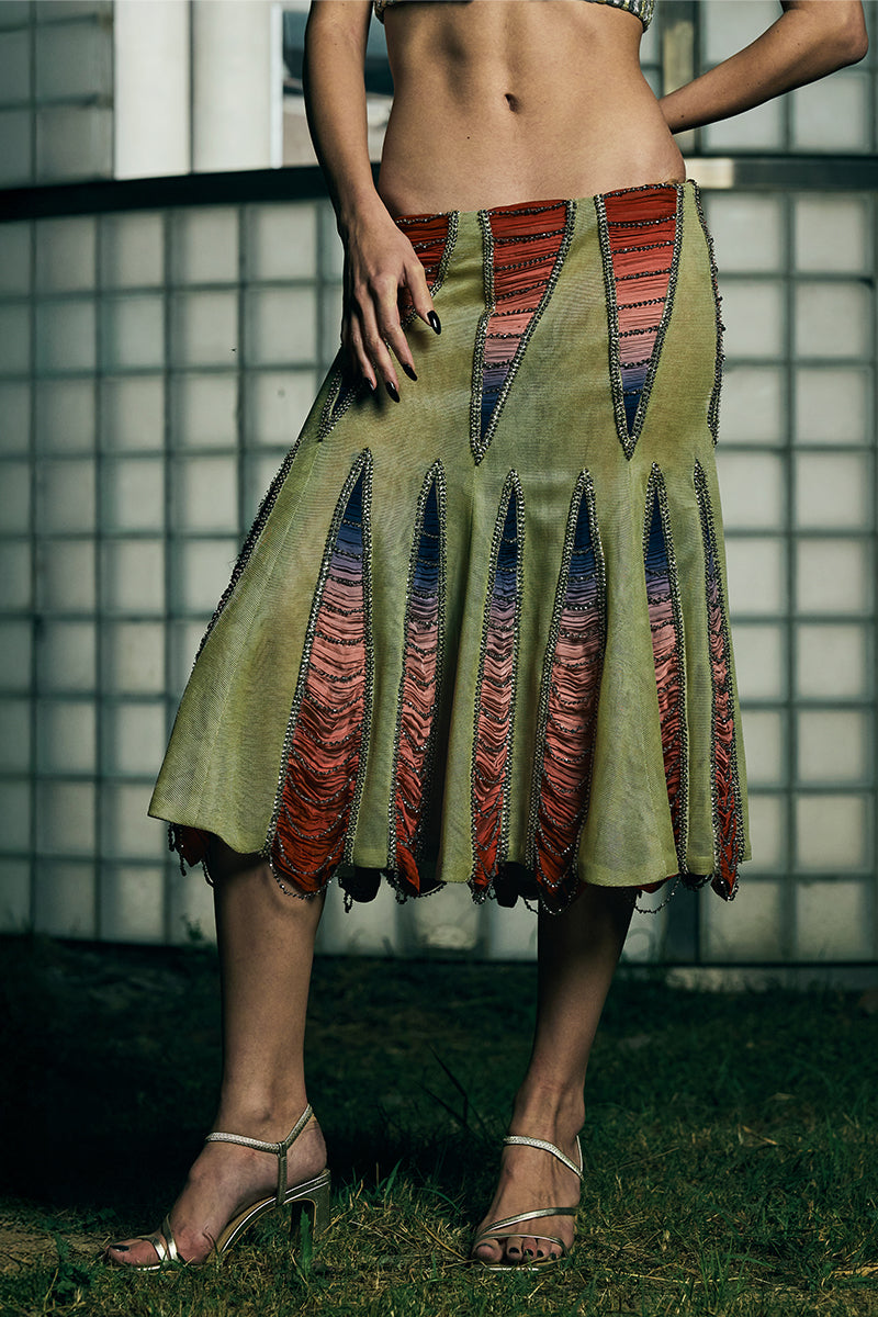 Low-waist panelled midi skirt by AKHL featuring a fitted waist and flowing design, displayed on a mannequin.