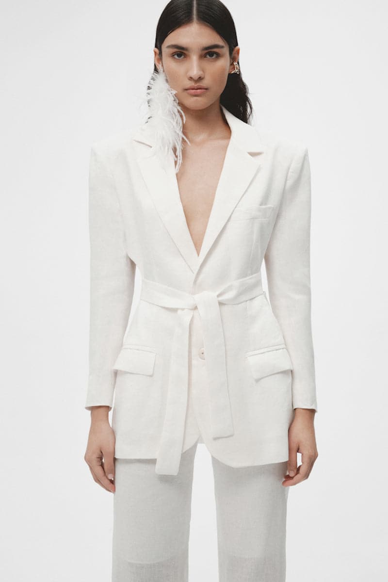 White organic linen cut-out blazer by JC Pajares, featuring a tailored fit and stylish design with cut-out details.