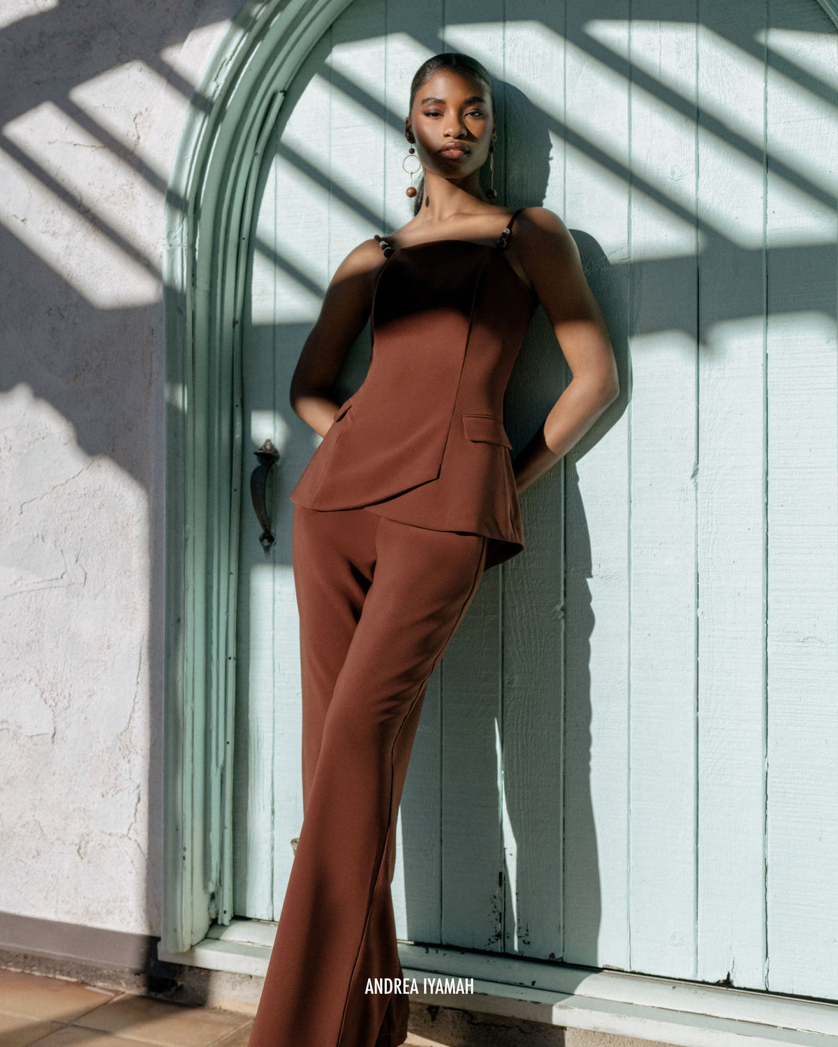Andrea Iyamah Atta Bootcut Pants in cinnamon, front view on model, showcasing stylish fall-winter pants with a relaxed fit.