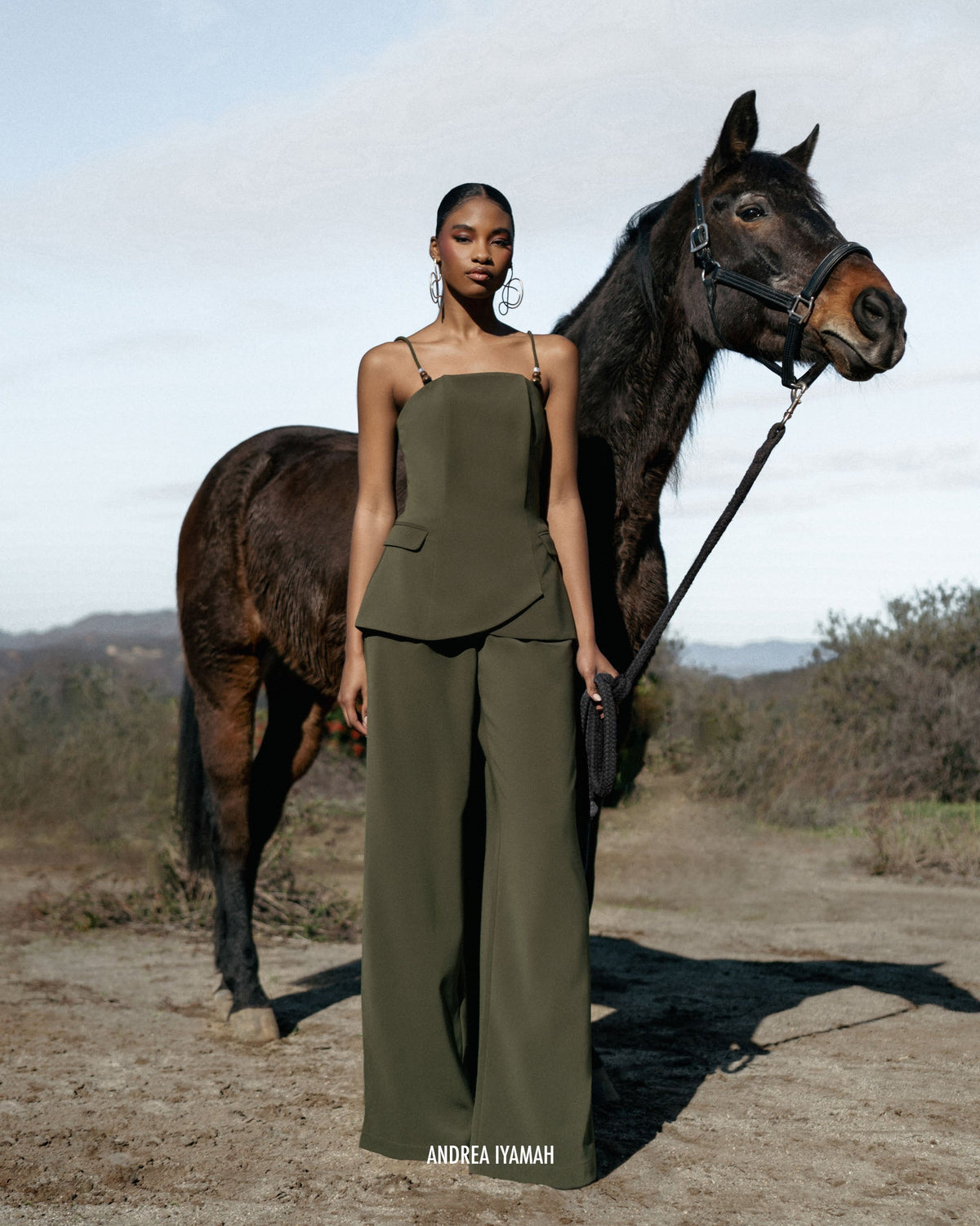 Andrea Iyamah olive bootcut pants from the fall/winter collection, shown on model with front view, highlighting the stylish fit.