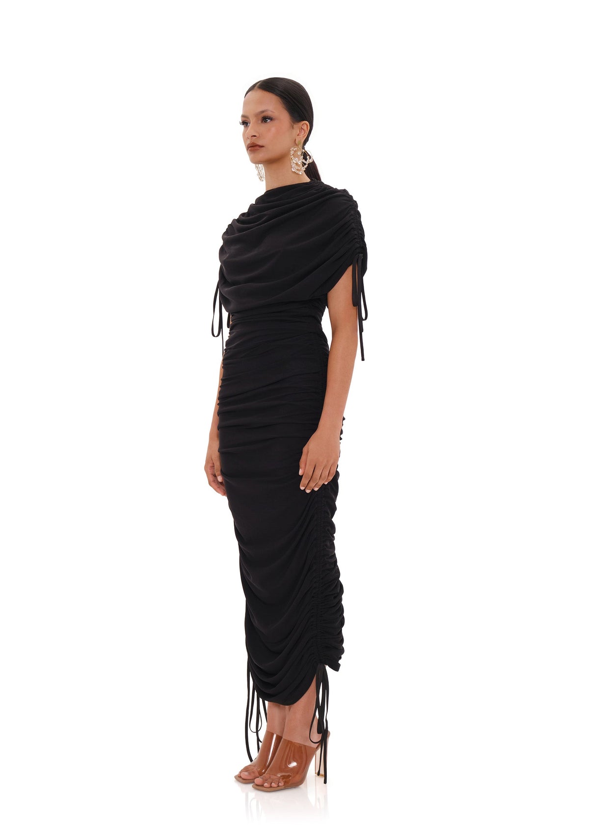 Black Ratu mesh maxi dress by Andrea Iyamah shown from side view with intricate mesh fabric and elegant flowing silhouette.