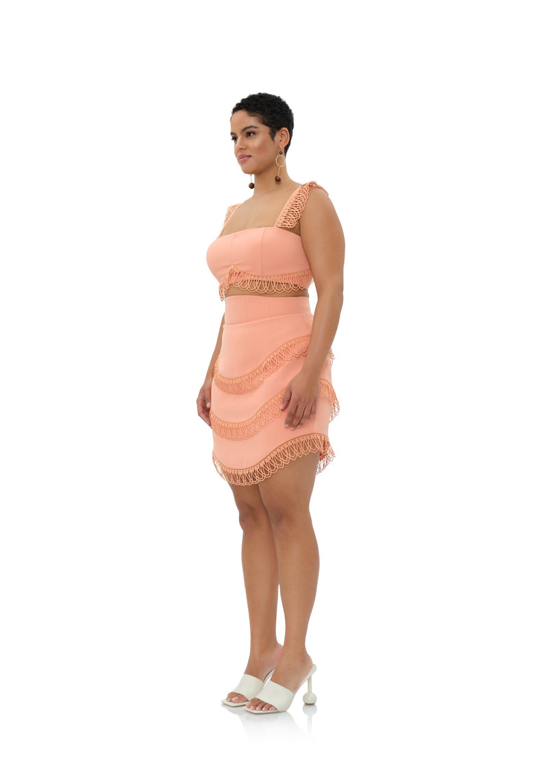 Peach Rizo powder mini skirt by Andrea Iyamah with a fitted waist and stylish design, shown on a model.