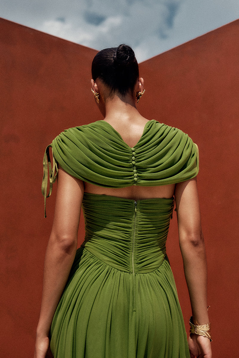 Bright olive KATU mesh maxi dress by Andrea Iyamah displayed on a model with flowing fabric and intricate mesh details.