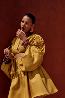 Bright gold INDA crop top by Andrea Iyamah, featuring a stylish design, shown on a model in a fashion lookbook image.