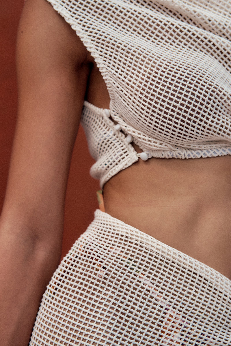 Ivory crochet cover-up dress by Andrea Iyamah featuring intricate patterns, perfect for beach or poolside wear.