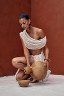 Ivory crochet cover-up dress by Andrea Iyamah, featuring intricate knit pattern and flowy design for beach or poolside wear.
