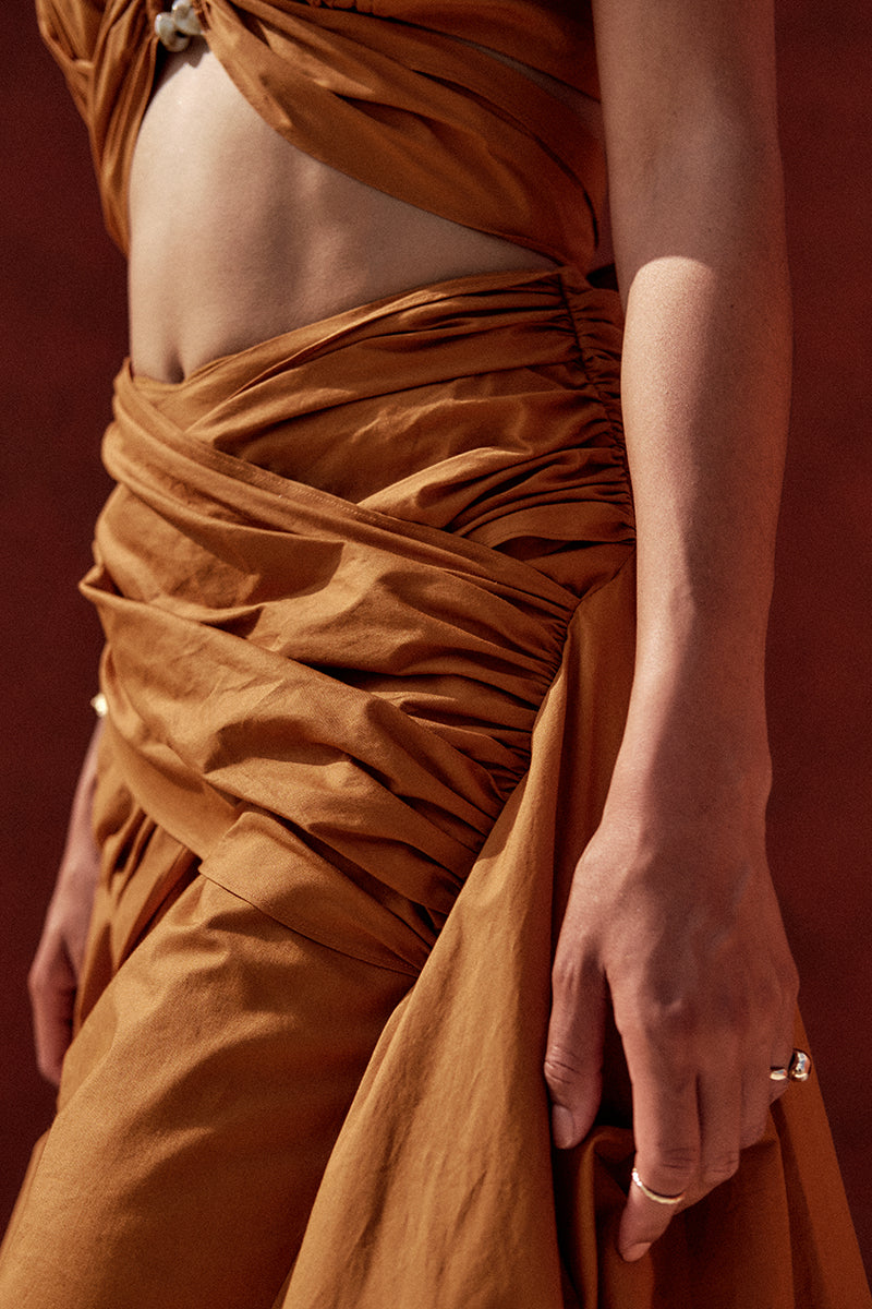 Burnt orange GIA crop top by Andrea Iyamah featuring a stylish, fitted design on a model.