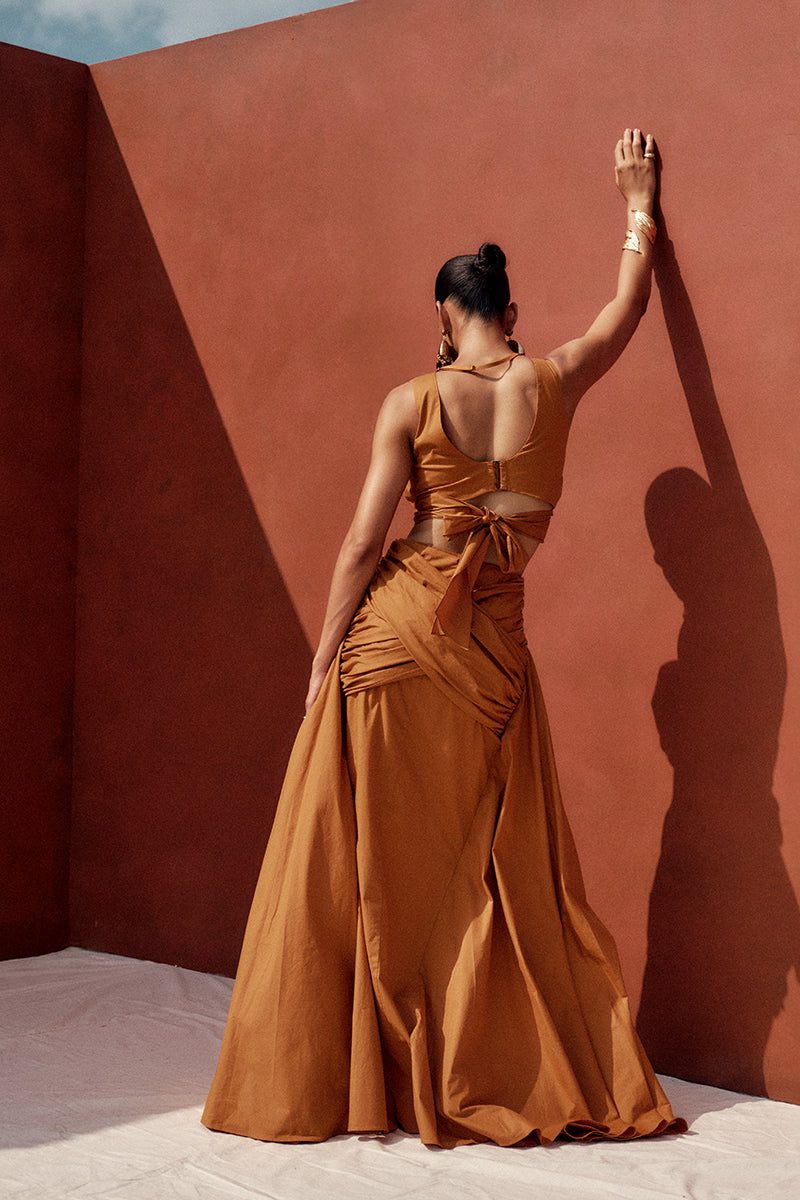 Andrea Iyamah GIA maxi skirt in burnt orange, flowing fabric with a stylish, elegant silhouette perfect for summer or casual wear.