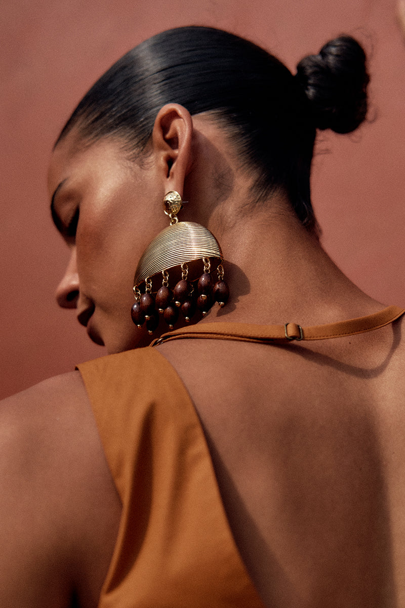 Burnt orange GIA crop top by Andrea Iyamah, featuring a stylish design, shown on a model in a fashion lookbook image.