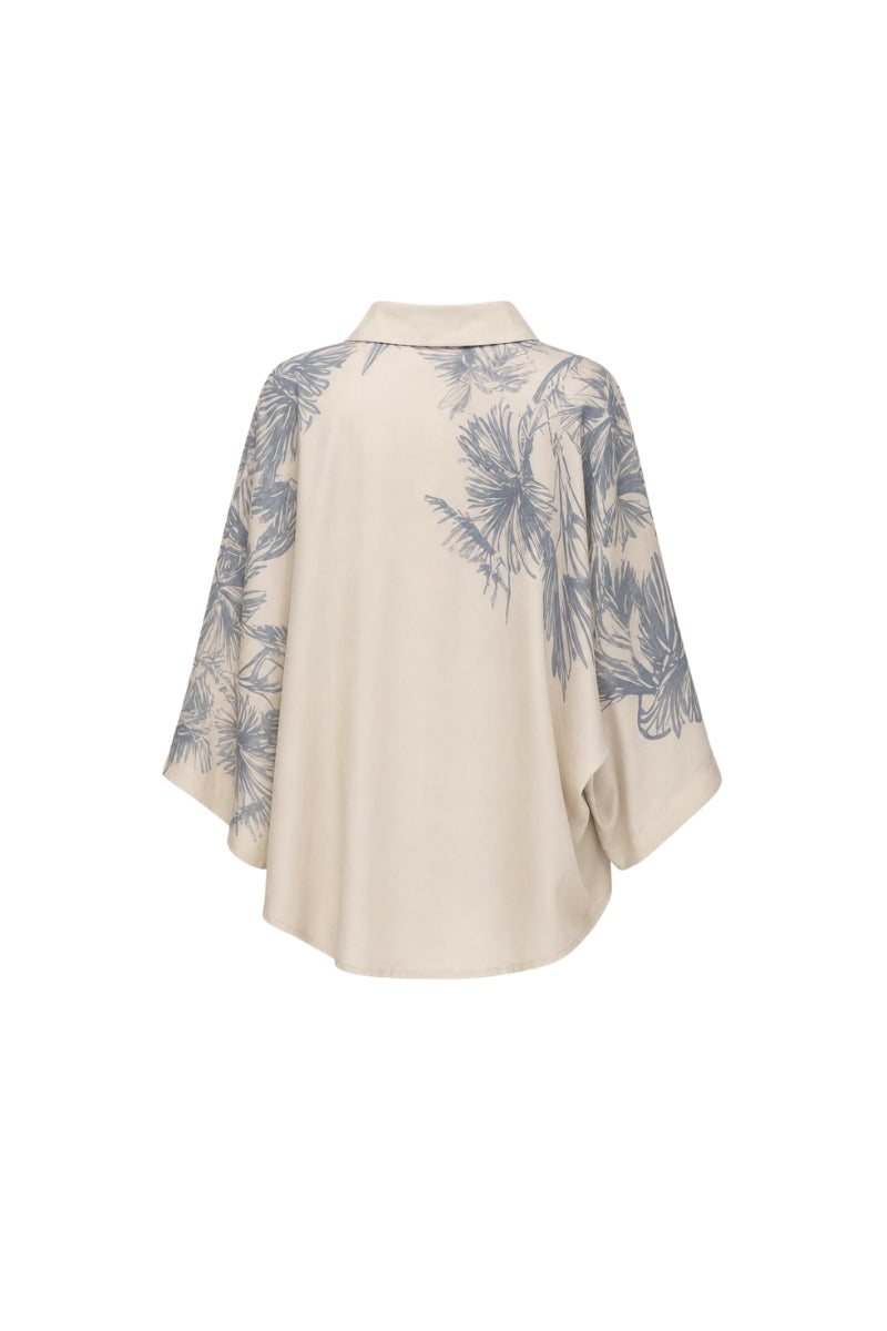 White Ankara blouse by Tinta Latina featuring intricate print details, styled as a fashionable women's top.