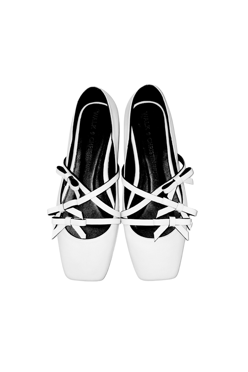 White Christin Wu Annaya flats with pointed toes and sleek design, perfect for casual or formal wear.
