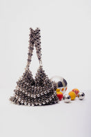 Silver Annie shoulder bag by Millanne Tale with pearl accents, stylish gray design, and adjustable strap.