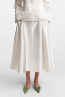 Podyh Iris midi skirt in cloud white, lightweight fabric with a flowing design and subtle pleats, stylish for casual or dressy wear.