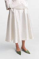 PODYH Iris midi skirt in cloud white with a flowy silhouette, lightweight fabric, and elegant design, shown in a close-up image.