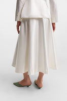 PODYH Iris midi skirt in cloud white fabric, featuring a flowing design and elegant length, perfect for stylish everyday wear.
