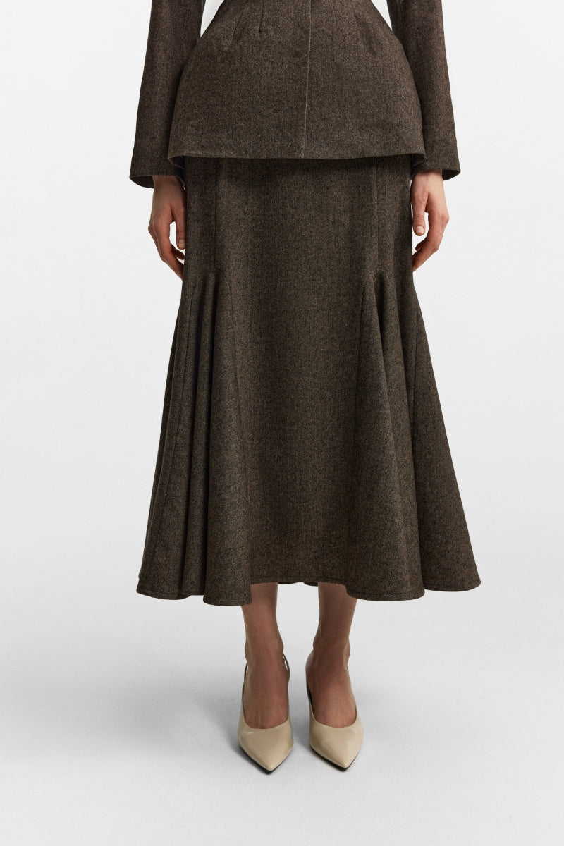 Podyh Seccesia midi skirt in rich brown, shown in a natural flowing style, with a high-waisted design and elegant fabric.