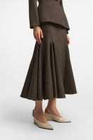 Podyh Seccesia midi skirt in rich brown with a flowing design, displayed on a mannequin with a neutral background.