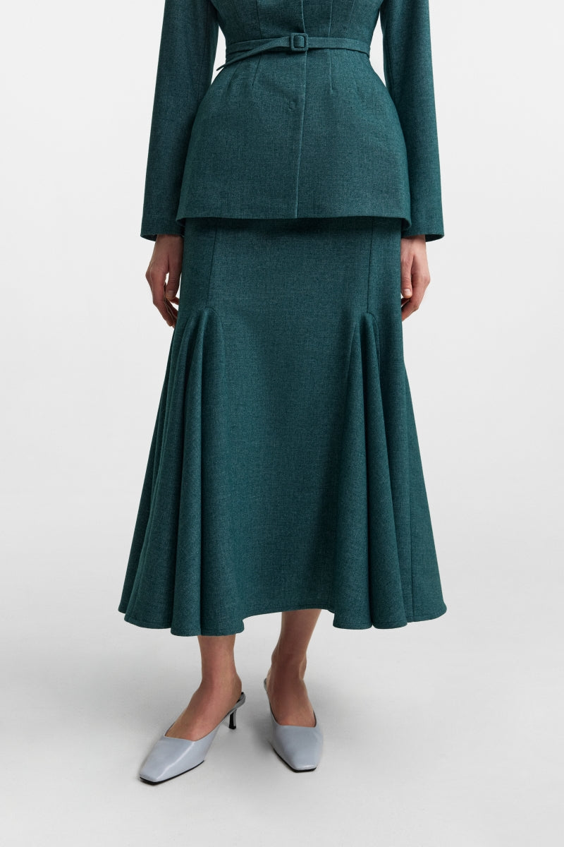 Podyh Secessia teal midi skirt with a fitted waist and flowing fabric, displayed on a hanger against a neutral background.