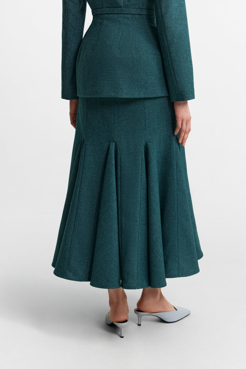 Podyh Secessia midi skirt in rich teal fabric, stylish and flowing, displayed on a hanger with a plain background.