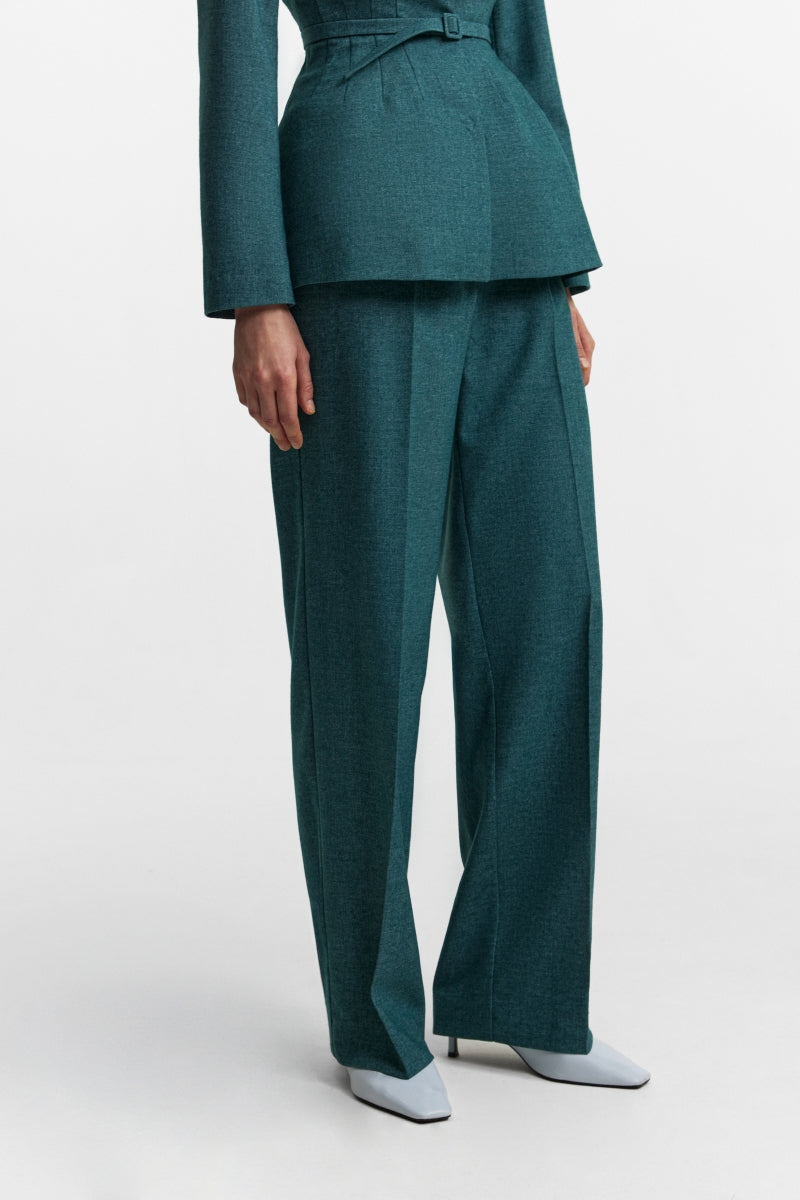 Podyh Seccesia pants in rich teal, stylish and comfortable pants with a relaxed fit and smooth fabric, shown on a hanger.