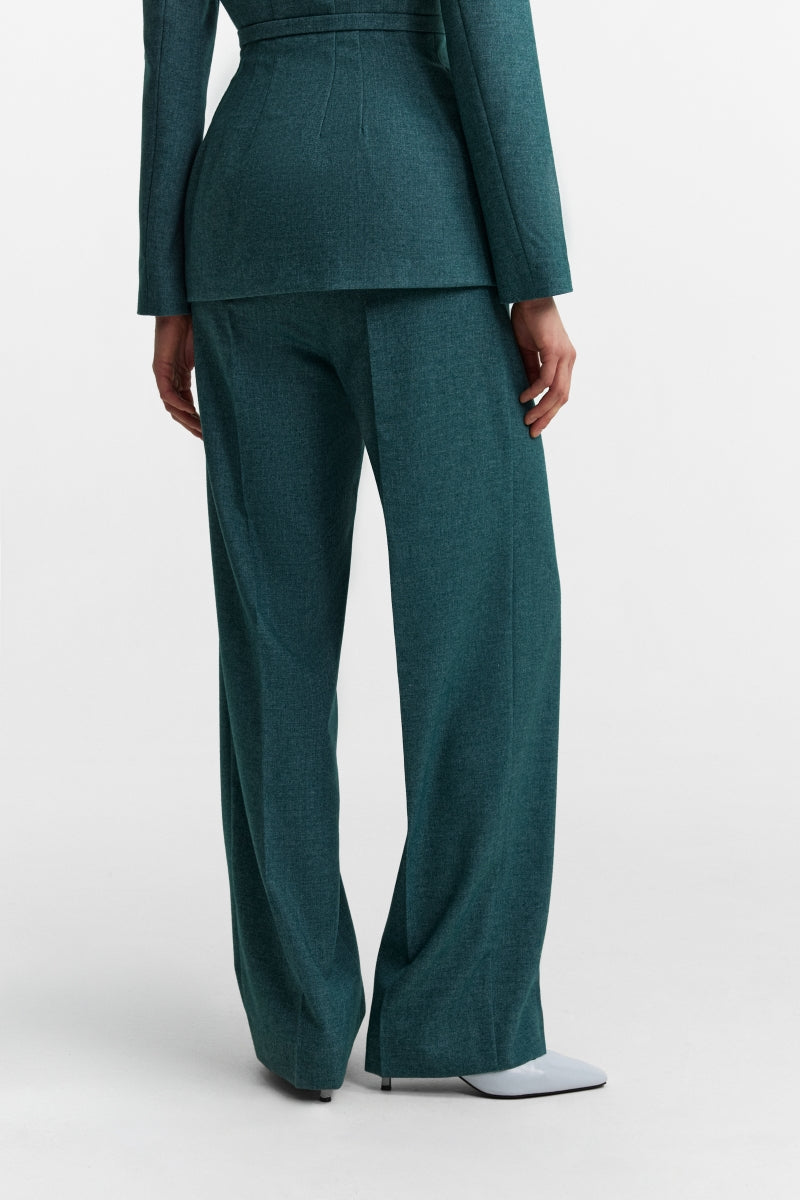 Podyh Seccesia pants in rich teal color, featuring a tailored fit and stylish design, displayed on a model.