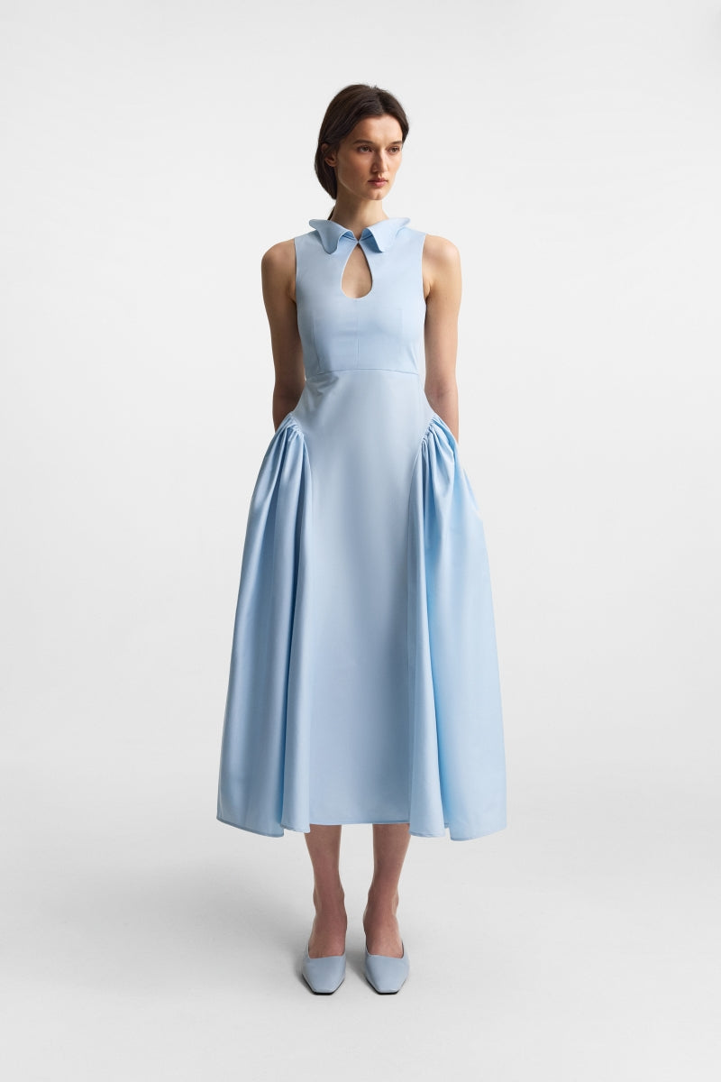 Celestial blue PODYH midi dress with a flowing silhouette and elegant design, displayed on a hanger against a neutral background.
