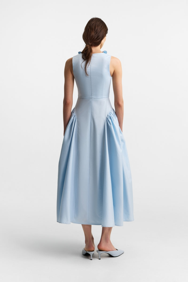 Celestial blue PODYH FOUET midi dress with flowing fabric and elegant design, displayed on a hanger.