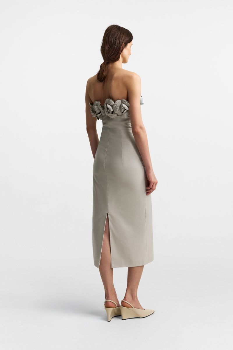 Podyh Capitel stone taupe midi dress with a fitted waist and elegant flowy fabric, displayed on a hanger.