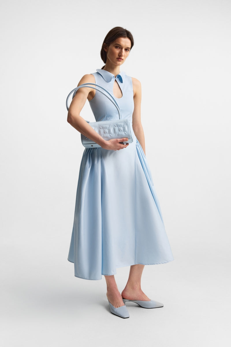 Ice blue PODYH top handle bag with bas relief design, showcasing elegant craftsmanship and sleek style.