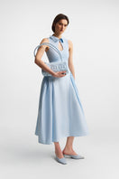 Ice blue PODYH top handle bag with bas relief design, showcasing elegant craftsmanship and sleek style.
