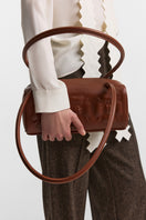 Brown PODYH top handle bag with bas relief design, featuring a stylish and elegant bag with textured detailing.