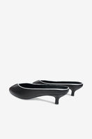 Black AQUILA heels by 10TH FLOOR with pointed toes and stiletto heels, displayed on a neutral background.