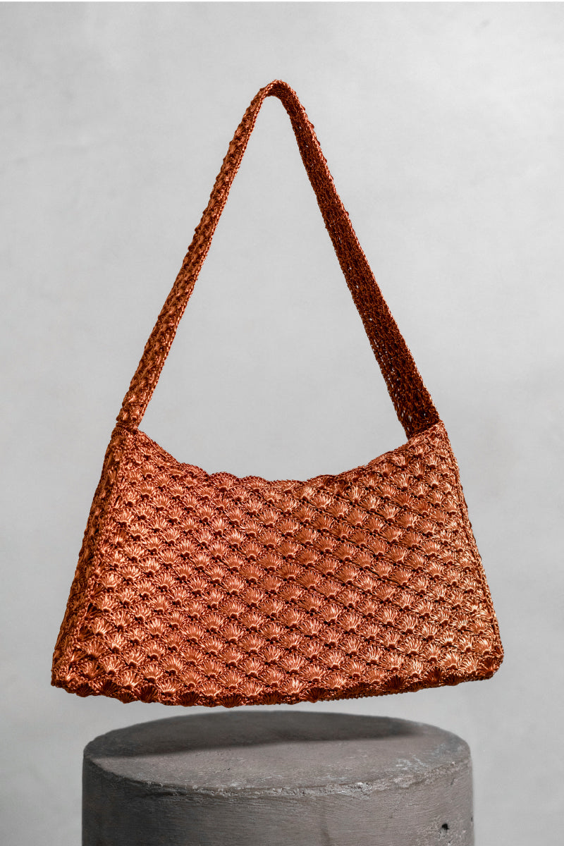 Verdi Arista seashell-shaped shoulder bag in copper with textured surface and adjustable strap, stylish accessory for casual or evening wear.