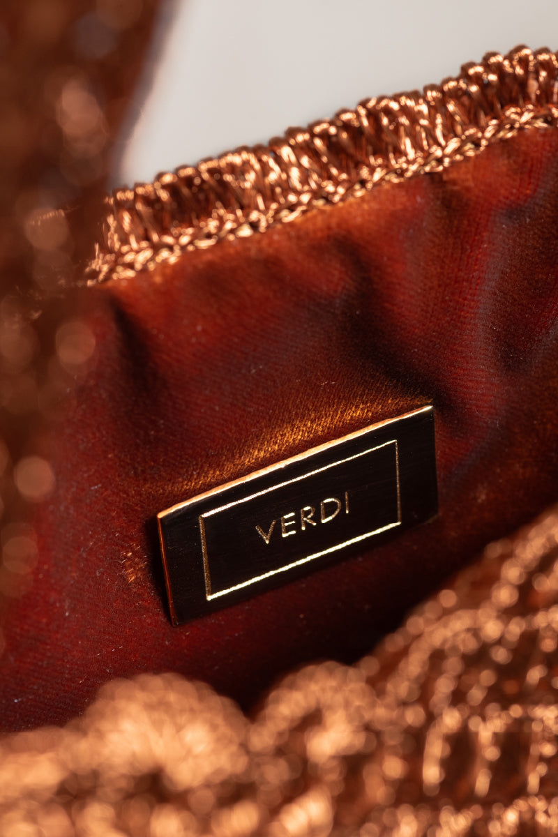 Verdi Arista seashell shoulder bag in copper with textured shell design and adjustable strap.