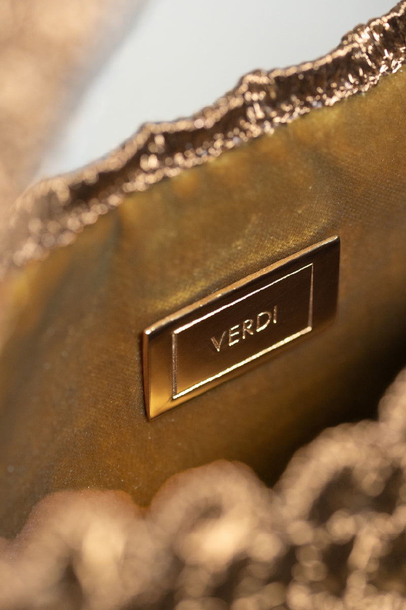 Verdi Arista seashell shoulder bag in antique brass with detailed shell design and adjustable strap, stylish and elegant accessory.