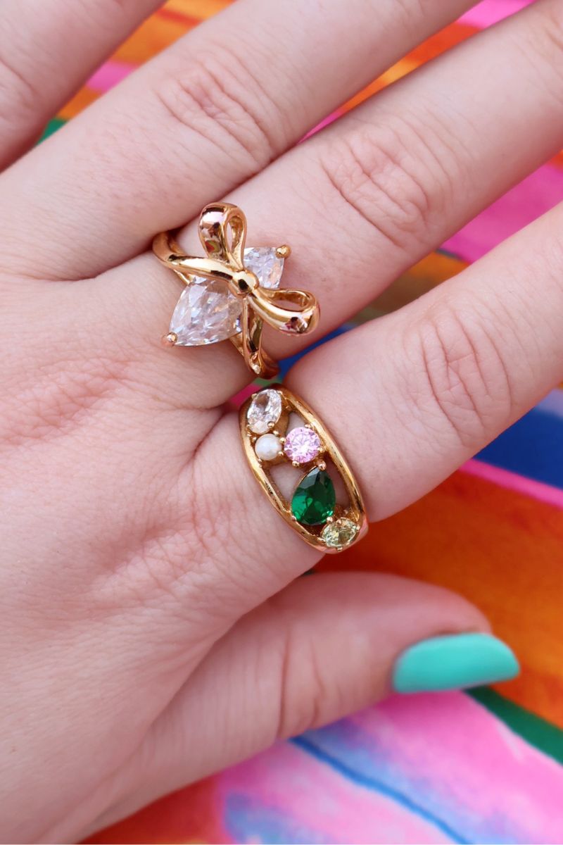 Amelia Scott Sofia cluster ring featuring flamingo and gold accents, showcasing a delicate and colorful jewelry design.