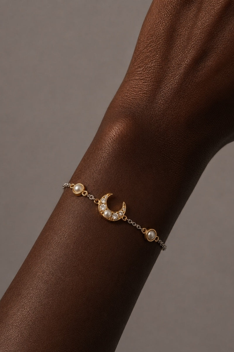 Silver and gold Luna Two Tone Pearl Moon Bracelet by Amelia Scott featuring a sleek, elegant design with pearl accents.