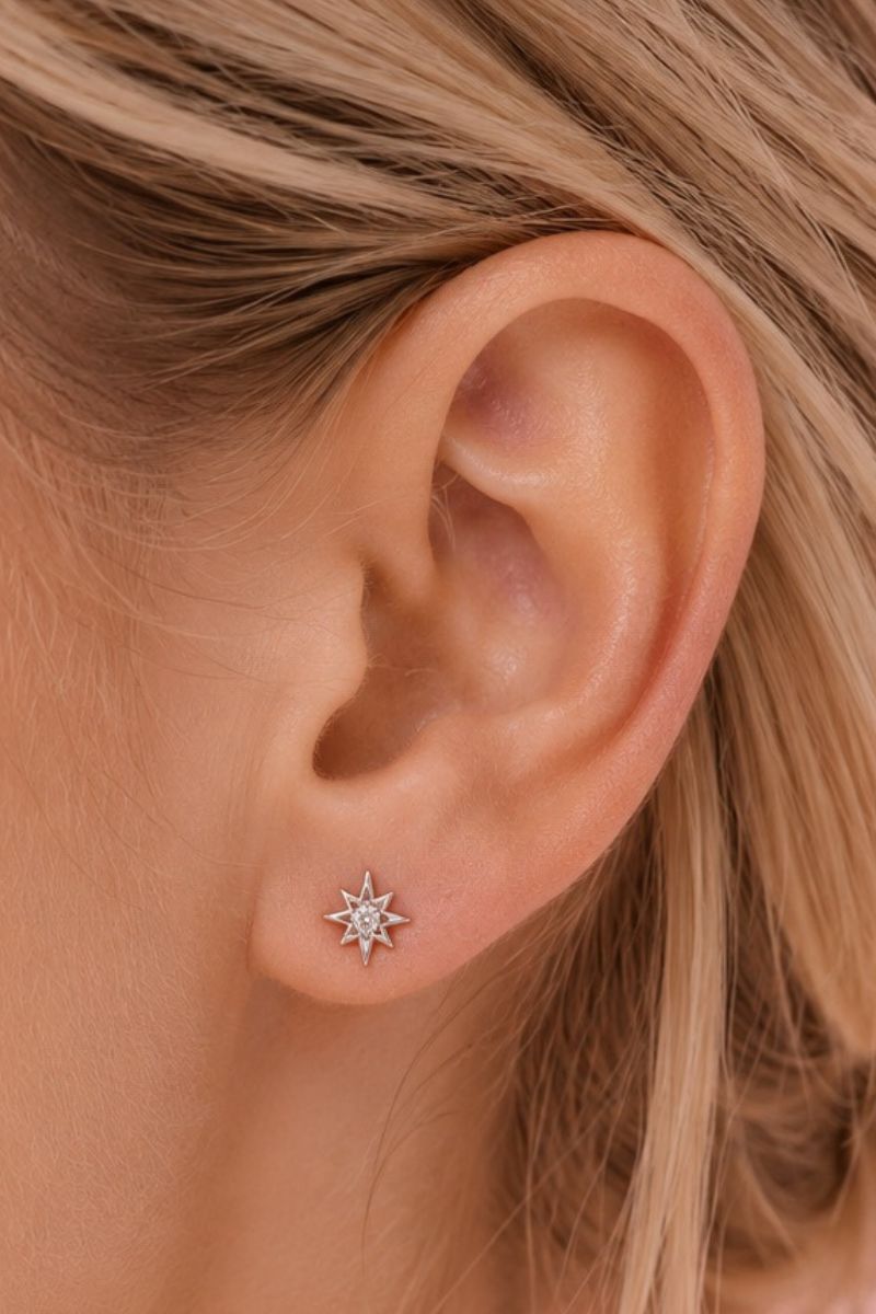 Silver and clear ZIGGY MINI NORTH STAR stud earrings by Amelia Scott, featuring star-shaped design and shiny finish.