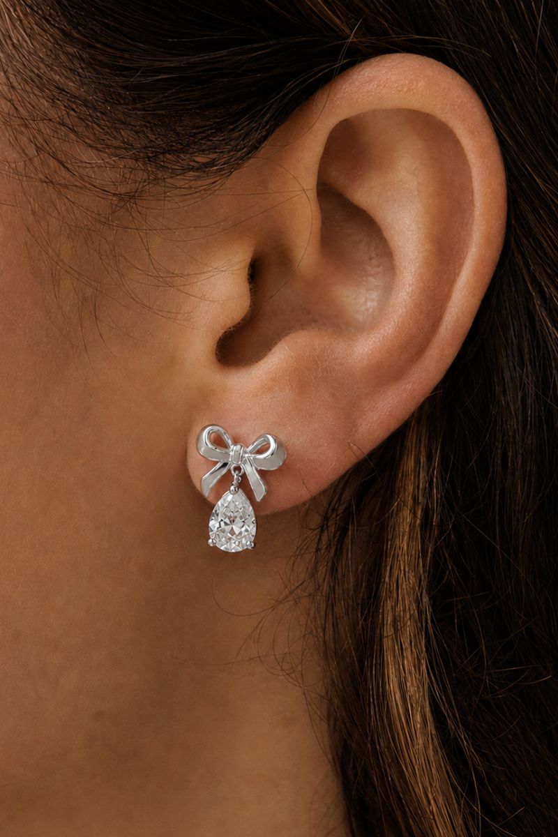 Silver Amelia Scott bow stud earrings with a polished finish, showcasing elegant, small bow designs for a subtle, stylish look.