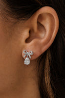 Silver Amelia Scott bow stud earrings with a polished finish, showcasing elegant, small bow designs for a subtle, stylish look.