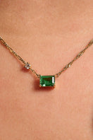 Emerald green and gold necklace by Amelia Scott featuring a delicate chain and elegant pendant on a white background.