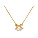 Gold Amelia Scott necklace with clear cubic zirconia bow pendant, elegant jewelry piece for stylish accessorizing.